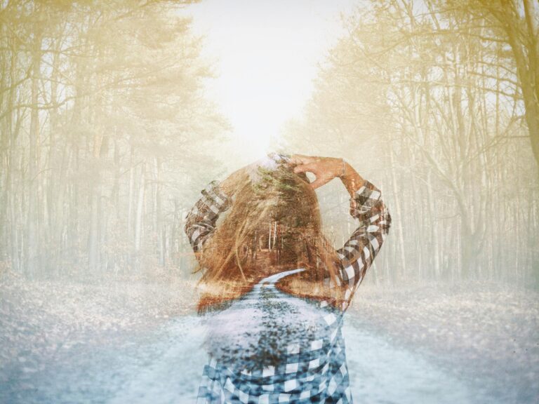 Artistic double exposure of a woman in a checkered shirt blending with a forest trail. Dreamy and mysterious.